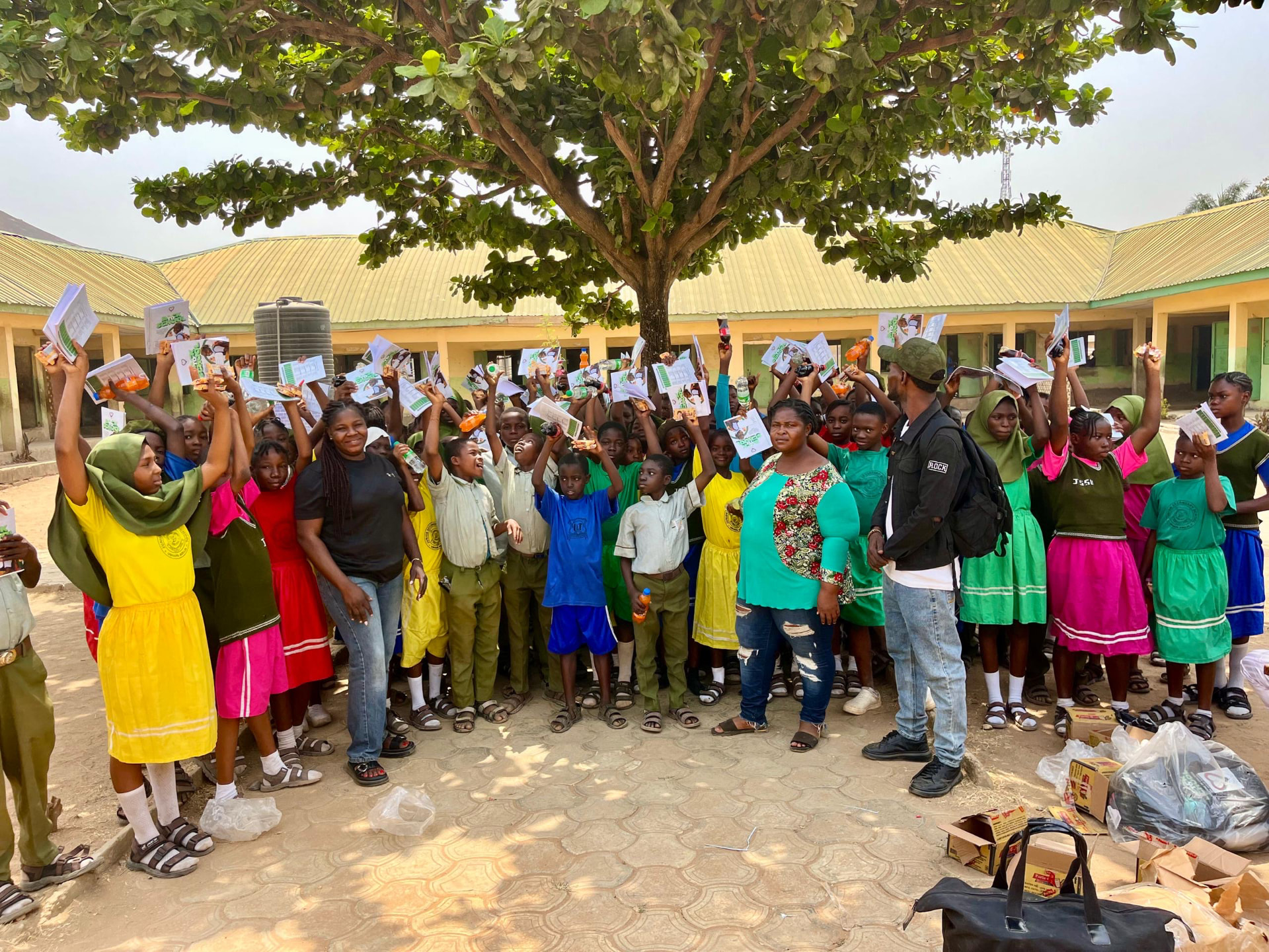 Schoolchildren celebrating with new books and supplies during a Back to School outreach